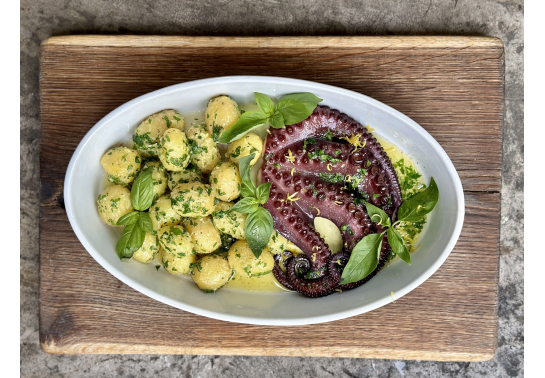 HALF OF A BAKED OCTOPUS WITH POTATOES