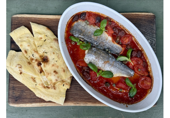 Baked sea bass fillet with tomatoes and capers