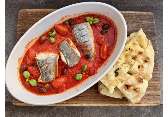 Baked sea bass fillet with tomatoes and capers